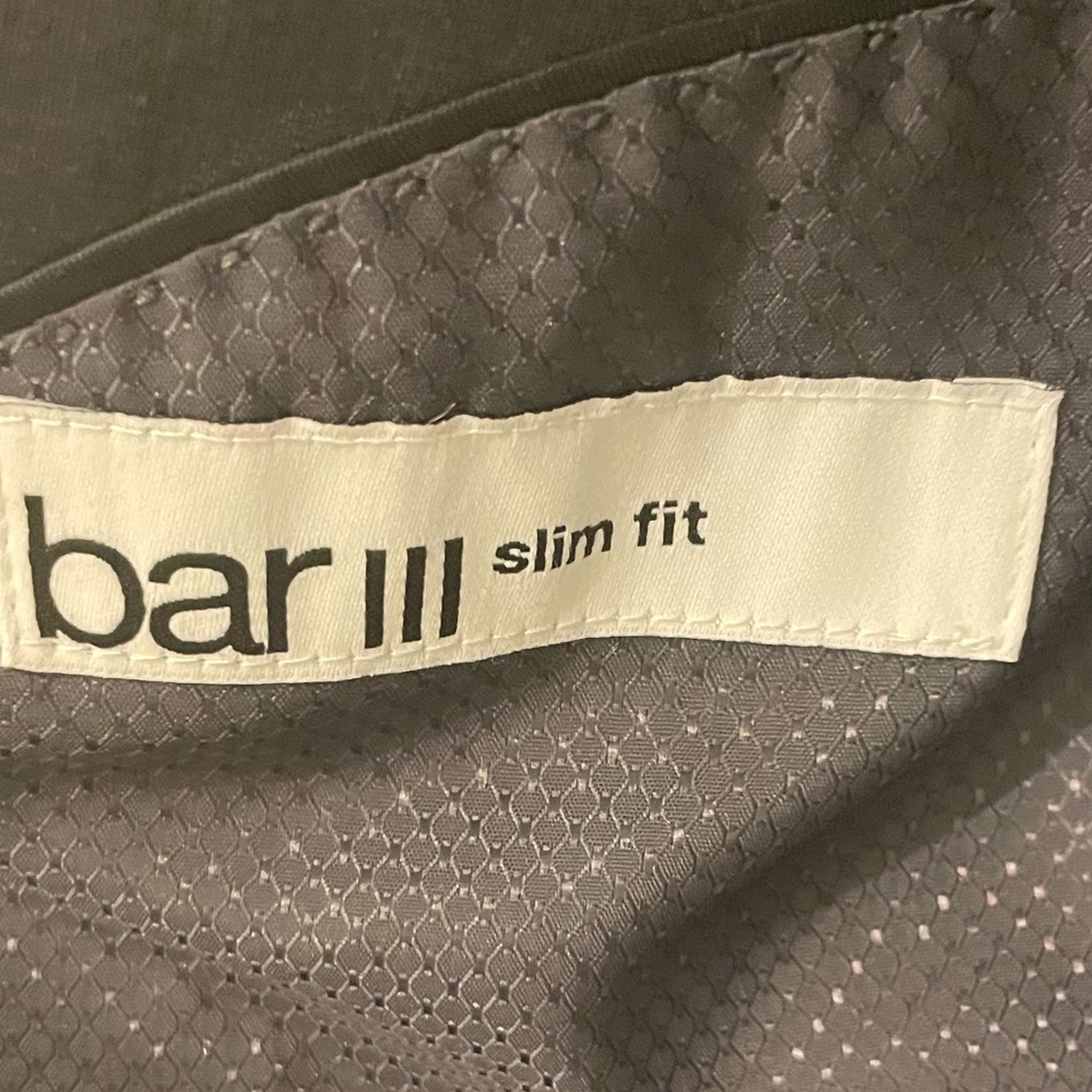 Three piece grey Bar III men slim fit suit. Jacket, pants, and vest.